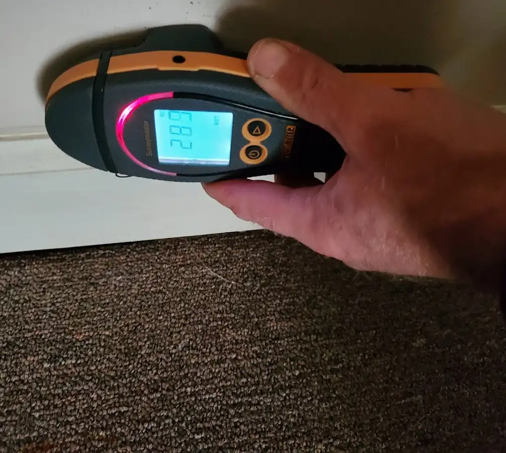 Moisture detection at baseboard during Storm Damage Restoration in Clanton